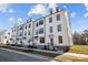 Row of three story townhouses with white siding and gray roofs at 13005 Moon Rd # 43, Charlotte, NC 28277