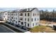Modern three-story townhouses in a new development, featuring white exteriors at 13005 Moon Rd # 43, Charlotte, NC 28277
