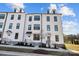 Three-story white townhome with a charming front porch at 13005 Moon Rd # 43, Charlotte, NC 28277