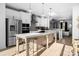 Modern kitchen with island, stainless steel appliances, and white cabinetry at 13005 Moon Rd # 43, Charlotte, NC 28277