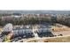 Aerial view of new townhouses under construction with a pond nearby at 13009 Moon Rd # 42, Charlotte, NC 28277