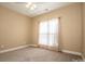 Well lit bedroom with carpeted floors and window coverings at 131 Quail Haven Dr, Troutman, NC 28166
