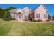 Brick home with a landscaped lawn and large windows at 131 Quail Haven Dr, Troutman, NC 28166