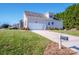 Attached garage with a long driveway and mailbox at 131 Quail Haven Dr, Troutman, NC 28166