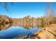 Serene lake view with calm water and tree-lined shoreline at 131 Quail Haven Dr, Troutman, NC 28166