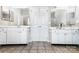 Double vanity bathroom with white cabinets, mirrors, and tile flooring at 157 Sandreed Dr, Mooresville, NC 28117