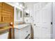 Bathroom boasts white vanity, granite counter, and wooden shelving unit at 157 Sandreed Dr, Mooresville, NC 28117