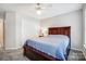 Bright bedroom features wooden bed, closet, and carpeted floors at 157 Sandreed Dr, Mooresville, NC 28117