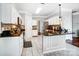 Bright kitchen with white cabinetry, granite counters, and stainless steel appliances at 157 Sandreed Dr, Mooresville, NC 28117