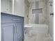 Bathroom with blue vanity and grey marble tile at 2515 Dion Ave, Charlotte, NC 28212