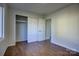 Well-lit bedroom with hardwood floors and double-door closet at 2515 Dion Ave, Charlotte, NC 28212