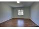 Bright bedroom featuring hardwood floors and a window with street view at 2515 Dion Ave, Charlotte, NC 28212