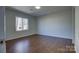 Spacious bedroom with hardwood floors and a large window at 2515 Dion Ave, Charlotte, NC 28212