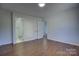 Well-lit bedroom with hardwood floors and access to a bathroom at 2515 Dion Ave, Charlotte, NC 28212