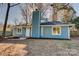 Newly renovated blue house with a landscaped yard and walkway at 2515 Dion Ave, Charlotte, NC 28212