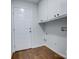 Bright laundry room with ample storage and wood flooring at 2515 Dion Ave, Charlotte, NC 28212