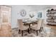 Spacious dining area with a wooden table, six chairs, and a large clock at 3035 Fallswood Dr, Gastonia, NC 28052