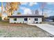 Newly built light gray house with dark metal roof, landscaping, and a paved driveway at 3035 Fallswood Dr, Gastonia, NC 28052