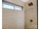 Clean shower with modern showerhead and neutral tile at 3035 Fallswood Dr, Gastonia, NC 28052