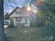 Fixer-upper home with front porch and mature trees at 307 E Arch St, Lancaster, SC 29720