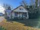 Quaint one-story house with front porch and mature trees at 307 E Arch St, Lancaster, SC 29720