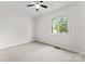 Bright bedroom with ceiling fan and window providing natural light at 3249 Farm Lake Sw Dr, Concord, NC 28027