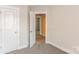Bedroom with carpeted floors and neutral walls, offering access to another room at 358 Camden Nw Ct, Concord, NC 28027