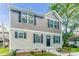 Two-story house with gray and beige siding, dark-colored shutters, and a landscaped yard at 358 Camden Nw Ct, Concord, NC 28027