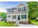 Two-story house with gray and beige siding, landscaping, and a concrete walkway at 358 Camden Nw Ct, Concord, NC 28027
