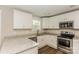 Modern kitchen with white cabinets, granite countertops, and stainless steel appliances at 358 Camden Nw Ct, Concord, NC 28027