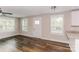 Living room with hardwood floors, white door, and neutral walls at 358 Camden Nw Ct, Concord, NC 28027