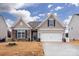 House exterior featuring stone accents and a two-car garage at 4471 Dover Ct, Denver, NC 28037