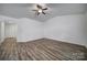 Open living room with vaulted ceiling, wood-look floors, and ceiling fan at 5217 Upton Pl, Charlotte, NC 28215