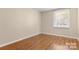 Simple bedroom with light walls and wood-look floors at 6100 Carpenter Dr, Charlotte, NC 28226