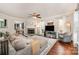 Living room with a fireplace, hardwood floors, and sectional sofa at 7422 Henderson Park Rd, Huntersville, NC 28078