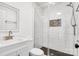 Modern bathroom with white tile, a glass shower, and gold fixtures at 941 Newcastle Rd, Gastonia, NC 28052