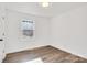 Bright bedroom with wood-look flooring and large window at 941 Newcastle Rd, Gastonia, NC 28052