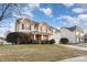 Two-story house with stone and siding accents, a landscaped yard, and a driveway at 11005 Magna Ln, Indian Trail, NC 28079