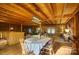 Rustic dining area with wood beams, round table, and striped tablecloth at 13195 Nc 801 Hwy Hwy, Mt Ulla, NC 28125