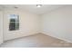 Empty bedroom with neutral carpet and bright window at 14113 Arbor Ridge Dr, Charlotte, NC 28273