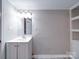 Simple and functional bathroom with white vanity, mirror, and updated flooring at 208 Oakland Dr, Lowell, NC 28098
