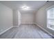 Bedroom with gray wood-look flooring, a window, and a white door at 208 Oakland Dr, Lowell, NC 28098