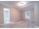 Empty bedroom with neutral walls, wood-look flooring, and a large window at 208 Oakland Dr, Lowell, NC 28098