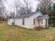 Side view of a single-story home with white siding and a yellow door at 208 Oakland Dr, Lowell, NC 28098