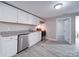 Updated kitchen featuring white shaker cabinets, granite countertops, and stainless steel appliances at 208 Oakland Dr, Lowell, NC 28098