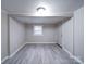 Bright living room with wood-look flooring, neutral walls, and a door to the exterior at 208 Oakland Dr, Lowell, NC 28098