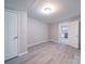 Spacious, open living area with neutral walls, wood-look floors, and access to the kitchen at 208 Oakland Dr, Lowell, NC 28098