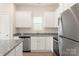 White kitchen cabinets, granite countertops, and stainless steel appliances at 3544 Clover Valley Dr, Gastonia, NC 28052