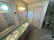 Bathroom with double vanity, shower, and floral wallpaper at 525 Ridgeland Dr, Cleveland, NC 27013