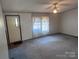 Carpeted living room with large window and ceiling fan at 525 Ridgeland Dr, Cleveland, NC 27013